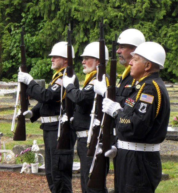 The Snoqualmie Valley Veterans Honor Guard presents arms at Fall City Cemetery.
