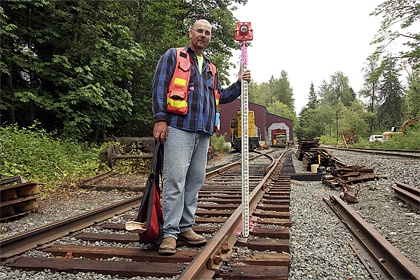 Jay McCombs of Issaquah-based Eastside Consultants helps survey the site of the Northwest Railway Museum’s proposed Train Shed Exhbiti building at its Stone Quarry Road campus.