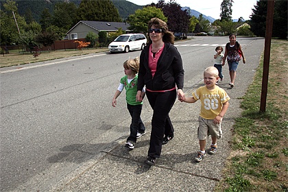 North Bend resident Jody Proudfoot walks her children home from school on Friday