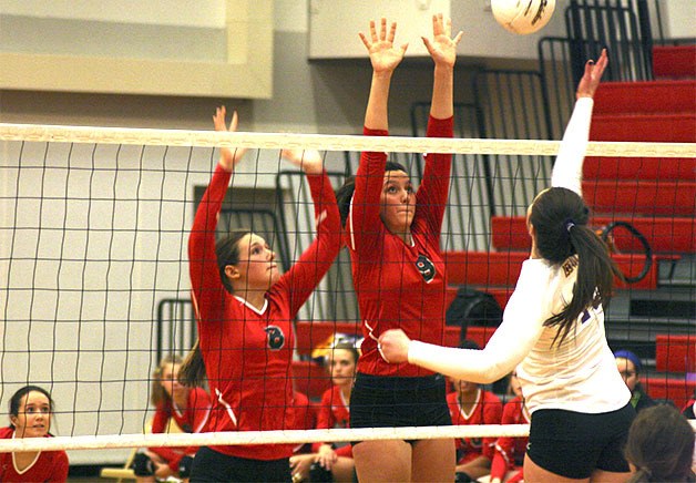 Mount Si varsity volleyball has been solidly handling foes this fall. Seniors Liz Larson and Anna McCreadie jump at the net to stop an issaquah hitter Thursday
