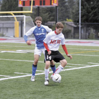 Chace Carlson of Mount Si battles for the ball against senior defender Anthony Kubeja