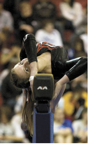 Mount Si sophomore Shanna Howland begins her beam routine during a Dec.  11 gymnastics competition that included Interlake