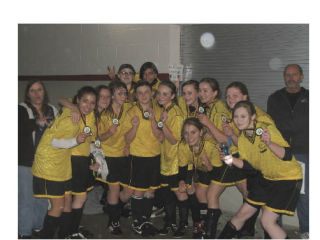 Members of the Roadrunners girls under-14 soccer team hold their trophy following a Tuesday