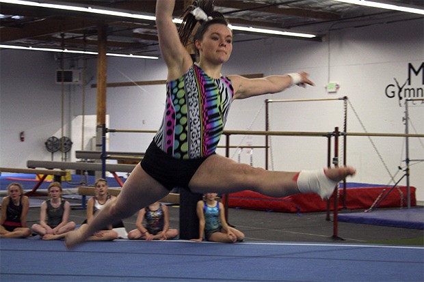 Mount Si's Jenn Rogers soars through her floor routine for the benefit of pupils at Mount Si Gymnastics Academy