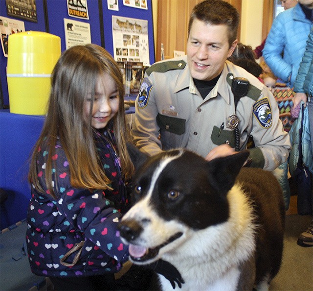 Presley Tes of North Bend meets Colter the Karelian Bear Dog after the presentation at the Cedar River Watershed Education Center. Colter has saved over 100 bears from being euthanized in his role as a wildlife service dog.