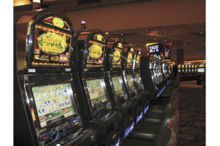 A row of gleaming slot machines stands ready for customers Monday afternoon inside the main hall of Snoqualmie Casino. The Snoqualmie Tribe’s new 170