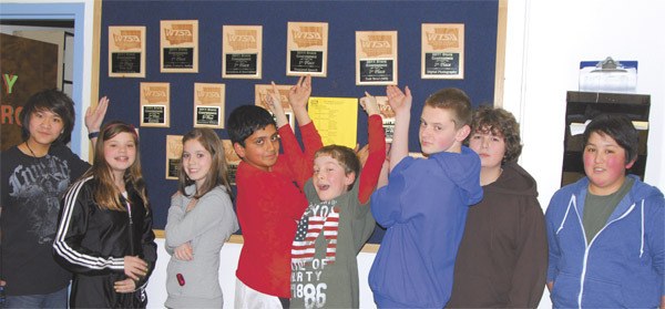 Tolt TSA Club members proudly point to  their trophies