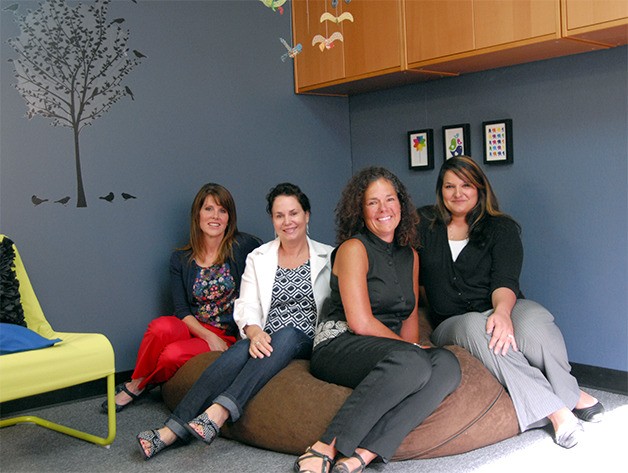 Bridge Academy staff and founders relax on one of the giant beanbags that will make the Academy a relaxed and comfortable place for individuals with disabilities to work on their goals. Pictured from left are Sally Coomer and Cindy O’Neill