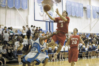 Mount Si’s Tanner Riley goes airborne for a layup  during play Friday against Interlake.