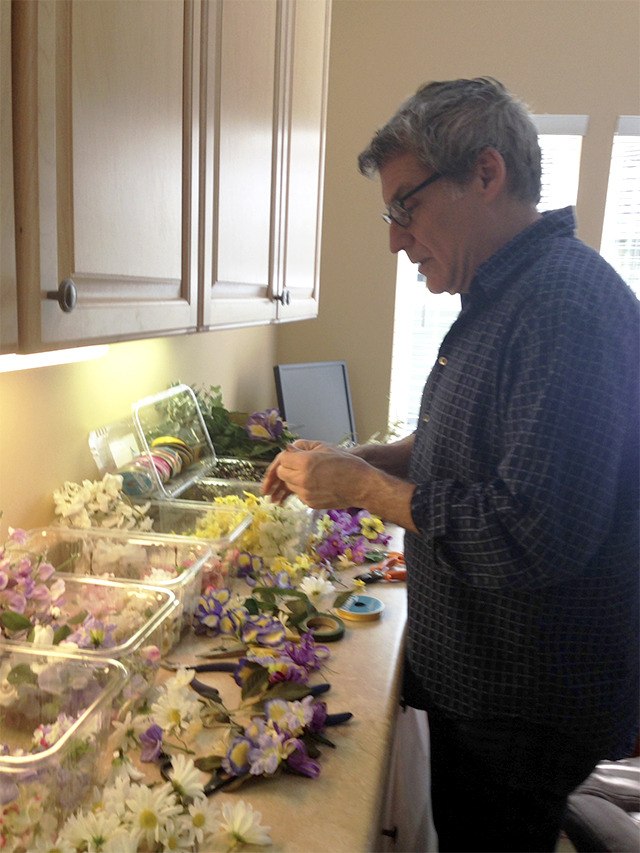 Stephen Haddan adds a finishing touch to  corsages for the Community prom March 22.