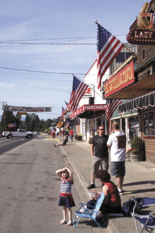 A girl waits beside Tolt Avenue for the Grand Parade to begin Saturday morning during the Carnation Fourth of July celebration.