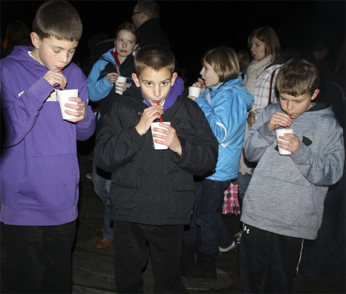 Boys sip on cocoa at the Fall City holiday celebration at the Art Park. The tree lighting follows a holiday concert at Chief Kanim Middle School this Saturday