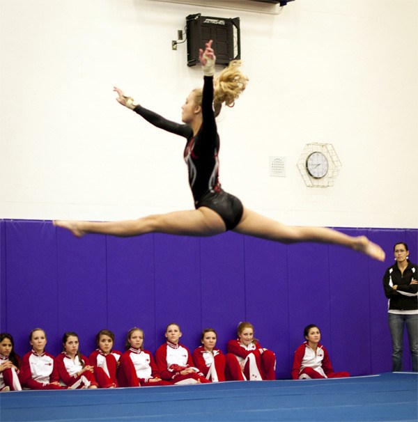 Wildcat Lexi Swanson performs a floor move during competition Thursday