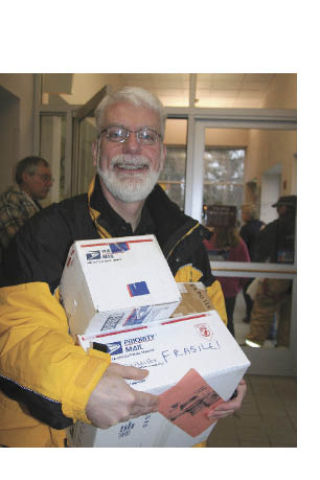 North Bend resident Bob Kaake delivers some of his final packages to the counter Wednesday