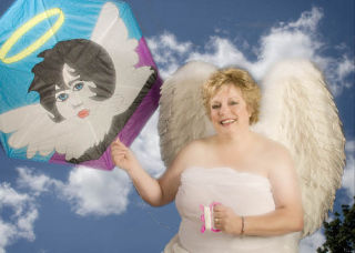 Valley resident Jill Holen dons angel’s wings in the 2009 calendar created by the Angel Care Foundation
