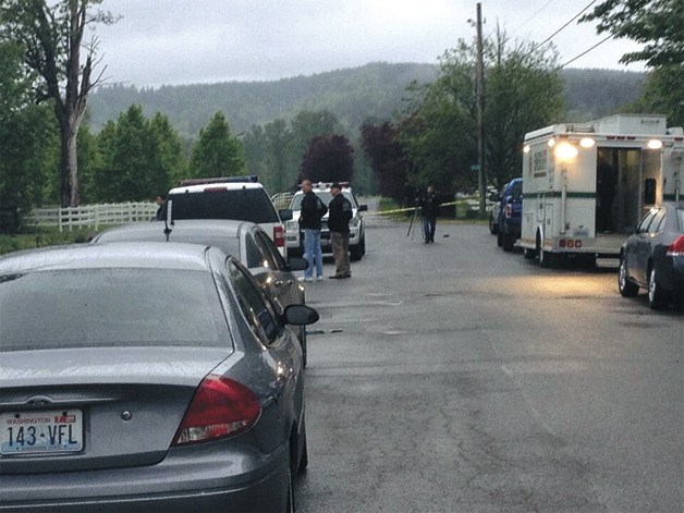 Sheriff’s deputies and camera crews line up outside the scene of a fatal home intrusion Monday morning near North Bend.