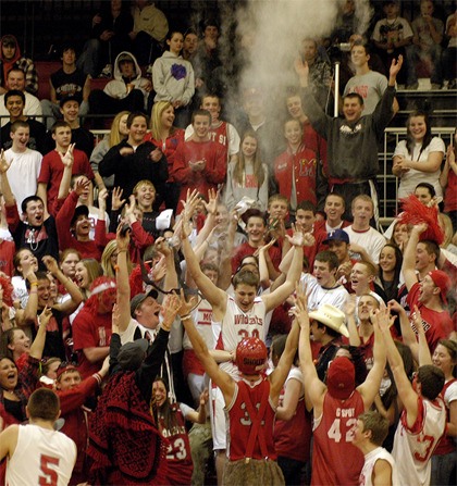 Wildcat senior Luc Zupan enters a crowd of fans after being introduced at the start of the Tuesday Feb. 9