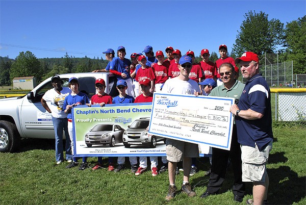 Members of the Snoqualmie Valley Little League accept an extra $500 donation from Chaplins North Bend Chevrolet