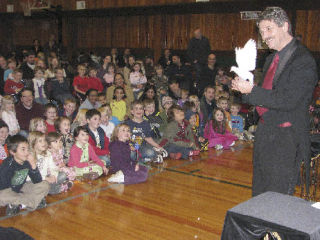 Magician Bruce Meyers mesmerizes a crowd of 270 children of all ages Friday evening