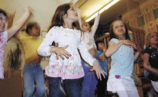 Snoqualmie resident Olivia Bahhage dances with more than a dozen other 5- and 6-year-olds to “Bop to the Hop” from “High School Musical