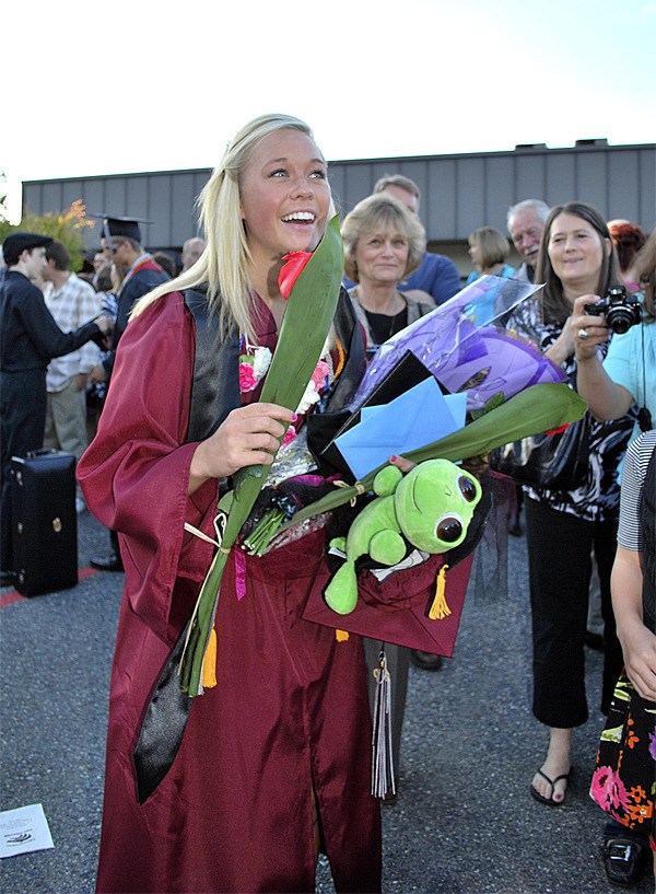 Cedarcrest graduate Missy Dowd accepts gifts from her family following commencement June 11.