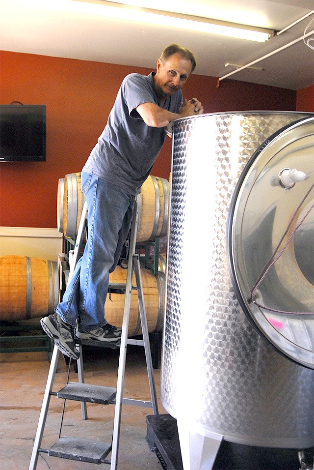 Wine maker Steve Bailey of Snoqualmie’s Sigillo Cellars looks into a wine tank