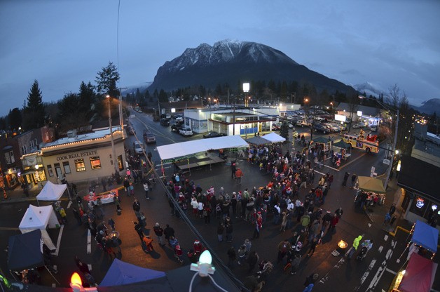 Residents gather at the community stage during North bend’s tree lighting festival in 2012. The festival returns on Saturday