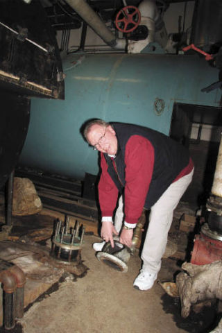 Snoqualmie district Operations Manager Carl Larson shows a worn-out valve inside a Mount Si High School boiler room that had to replaced recently.
