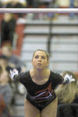 Mount Si’s Rachel Karavais leaps for the bars during competition at the bi-districts at Sammamish.