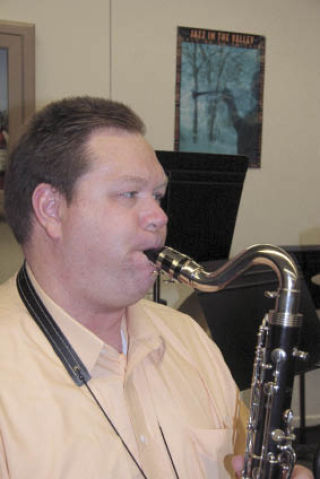 Jim Myers sounds his saxophone during rehearsal