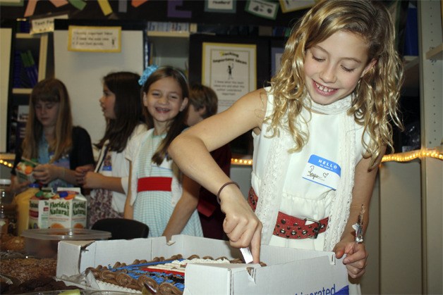 SES students serve cake and breakfast to visiting veterans at their assembly reception in 2012. Their assembly for Veterans Day is back this Friday.