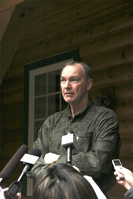 Neighbor Briggs Hall talks to reporters at his home