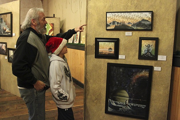 Jeff Sturgeon of Snoqualmie views art with his son at last year’s downtown holiday open house.  The event returns this weekend.