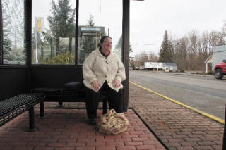 Metro bus rider Terry Cullen waits for a bus in downtown Snoqualmie. While Metro considers remedies to a funding shortfall