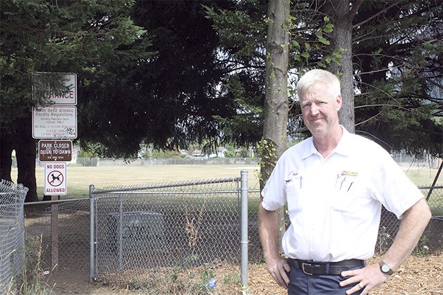 Les Schwab Manager Kevin Schallhorn stands on the site of a sliver of property his company will donate to the city of North Bend