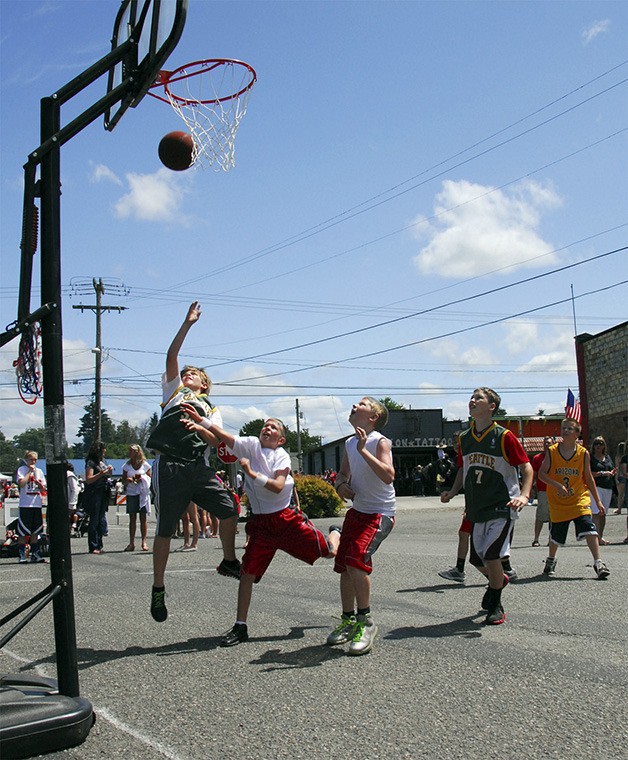 Boys hustle for a win in the recently created Just Moo It 3-on-3 basketball tournament