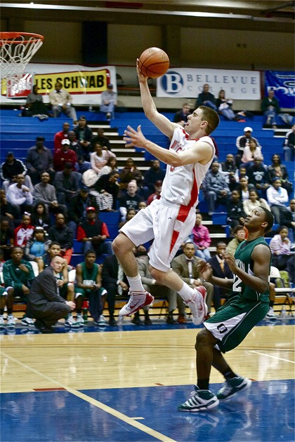 Mount Si’s Tanner Riley leaps into mid-air to lay the ball into the hoop with Franklin’s Juwuan Buchanan