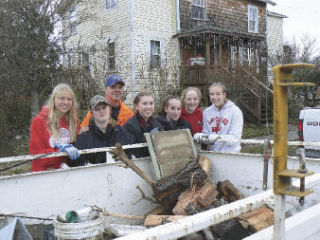 Mount Si High School girls basketball players and junior varsity head coach Larry White helped Snoqualmie residents clean up following the recent flooding. From left are Haley Chase