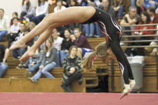 Mount Si’s Lexi Swanson goes head over heels on the mat during competition last Thursday