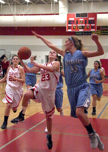 Mount Si junior guard Stevie Riley breaks for the basket past Interlake’s Sarah Anderegg during play Wednesday at home.