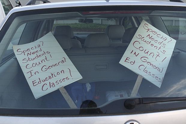 The back window of an educator's car in the Mount Si parking lot Sunday evening displays picket signs about special education. Snoqualmie Valley teachers were technically on strike Sunday afternoon