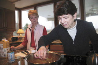 Snoqualmie Valley Relay for Life volunteers Mary Ann Rohrbach and Anne Loring taste a recipe submission for the new Relay for Life cookbook. Submissions help honor and remember those who have fought cancer.
