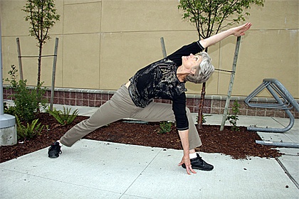 Yoga instructor Carla Orellana of North Bend demonstrates a lateral pose