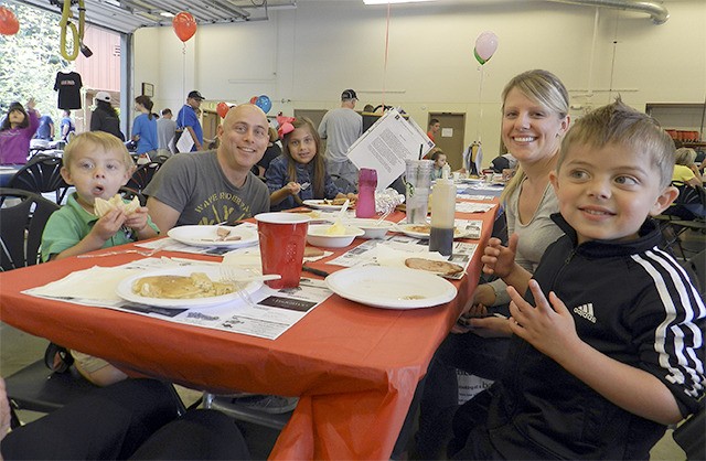 The Baker family enjoys a pancake breakfast together at the 2014 Railroad Days event.