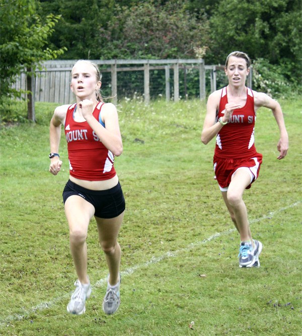 Freshmen Abbey Bottemiller and Bailey Scott cross the finish line in their first home 5-k competition Sept. 15. The Mount Si newcomers took fifth and sixth respectively.