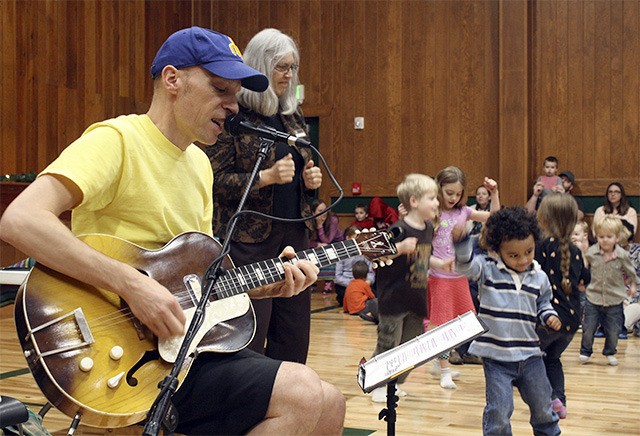 Ballew performs “Hey Jude” as dozens of children dance around him.