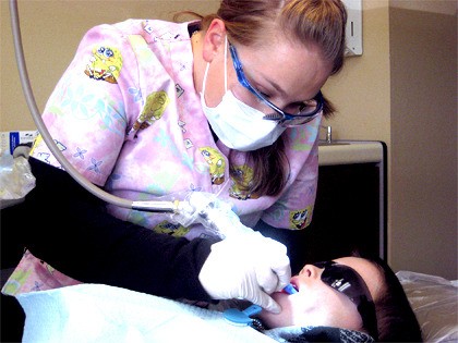 Dental assistant Heather Berta of Dr. James Browning's office cleans Jake Hall's teeth for the first time. Jake was one of 20 children who came in for Give Kids A Smile Day.
