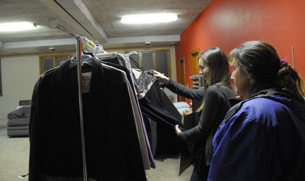 Making a rare find—a formal dress—student volunteer Audrey Miller sorts and hangs clothes for the Teen Closet