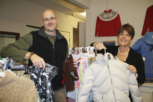 SVA Church Pastor Marty Wright and Gift of Apparel Director Jan Van Liew hang items at the clothing bank's new Snoqualmie location. Gift of Apparel now provides clothes to the needy at the former Snoqualmie City Hall