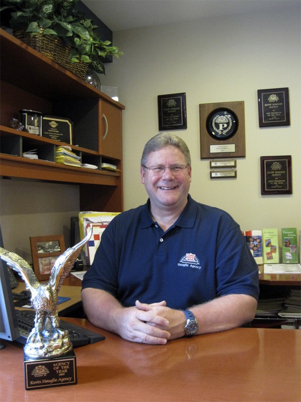 A brass eagle in Kevin Hauglie’s office proudly proclaims his agency’s status as the Farmer’s Insurance 2009 Agency of the Year.